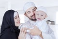 Muslim man hugging his child at home