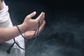 A Muslim man in ihram clothes praying with prayer beads on his hands Royalty Free Stock Photo