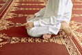 Muslim man kneeling while praying to god Royalty Free Stock Photo