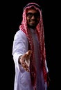 Muslim man is making handshake on black background Royalty Free Stock Photo