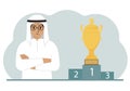 A muslim man next to the pedestal on which the cup for victory and first place.