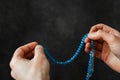 Muslim man praying blue rosary between his hands Royalty Free Stock Photo