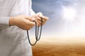 Muslim man praying with prayer beads on his hands on desert Royalty Free Stock Photo