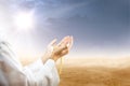 Muslim man praying with prayer beads on his hands in desert Royalty Free Stock Photo