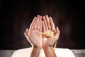 Muslim man praying with prayer beads on his hands in front of the opened quran