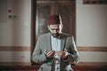 Muslim man praying and reading Quran