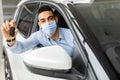 Muslim man in protective face mask buying new car Royalty Free Stock Photo