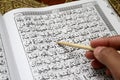 Holy Al Quran and prayer beads on the prayer mat