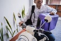 Muslim man ride motorcycle for idul fitri balik kampung mudik carrying suitcase Royalty Free Stock Photo