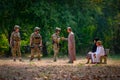 Muslim man shake hand with soldier man and his family stay near to him with concept of cooperate people during war Royalty Free Stock Photo