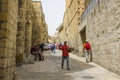 A Muslim man and tourists in a narrow side street off the Via Dolorosa