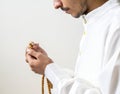 Muslim man using misbaha to keep track of counting in tasbih Royalty Free Stock Photo