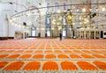 Muslim man walking on the carpet inside the famous Suleymaniye Mosque