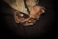 Muslim man wearing a brown djellaba and holding a rosary in his hands, photo, dark background