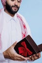 Muslim man opening gift box closeup Royalty Free Stock Photo