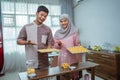 muslim man and woman bake nastar snack for idul fitri