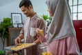 muslim man and woman bake nastar snack for idul fitri