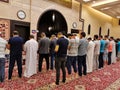 Muslim men praying in line in a mosque in Doha Qatar.Muslim Praying five daily prayer Together in A Mosque. muslim religious men