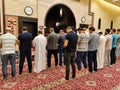 Muslim men praying in line in a mosque in Doha Qatar.Muslim Praying five daily prayer Together in A Mosque. muslim religious men