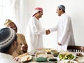 Muslim men shaking hands at lunchtime Royalty Free Stock Photo