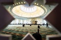 Muslim men sit on the floor while praying inside a beautiful mosque. The Islamic religion is a concept.