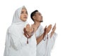 Muslim man and woman praying in white traditional clothes ihram