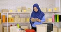 Muslim merchandiser checking order in the office