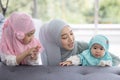 Muslim mom in hijab is her little daughter sitting in the living room, Loving Relationship Royalty Free Stock Photo