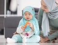 Muslim mom in hijab is her little daughter sitting in the living room, Loving Relationship Royalty Free Stock Photo