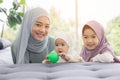 Muslim mom in hijab is her little daughter sitting in the living room, Loving Relationship Royalty Free Stock Photo