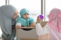 Muslim mom in hijab is her little daughter sitting in the living room, Loving Relationship Royalty Free Stock Photo