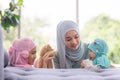 Muslim mom in hijab is her little daughter sitting in the living room, Loving Relationship Royalty Free Stock Photo