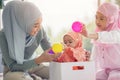 Muslim mom in hijab is her little daughter sitting in the living room, Loving Relationship Royalty Free Stock Photo
