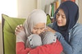 Muslim mother comforting her sad daughter, supportive mom help her girl Royalty Free Stock Photo