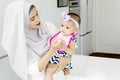 Muslim mother is feeding her cute baby Royalty Free Stock Photo