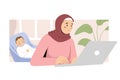 Muslim mother freelancer working at home office using laptop while her baby is sleeping, small business or remote