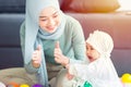 Muslim Mother happy smile enjoy playing with her baby  infant care happy together lovely home Royalty Free Stock Photo