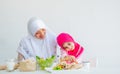 Muslim mother has action for motivating her daughter to eat vegetable, especially fresh tomatoes for good health