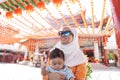 Muslim mother and her son together at a chinese temple Royalty Free Stock Photo