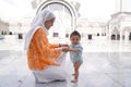 Muslim mother and her son together at a mosque Royalty Free Stock Photo