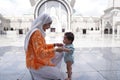 Muslim mother and her son together at a mosque Royalty Free Stock Photo