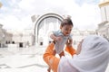 Muslim mother and her son together at a mosque Royalty Free Stock Photo