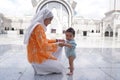 Muslim mother and her son together at a mosque Royalty Free Stock Photo