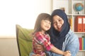 Muslim mother playing with her baby girl, mom and daughter love each other, happy single parent Royalty Free Stock Photo