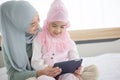 Muslim Mother working with tablet and Cute little baby at home Royalty Free Stock Photo