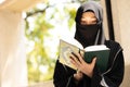 Muslim niqab woman read and learning the Quran and faith The Holy Al Quran book. Arab saudi black chador lady Royalty Free Stock Photo