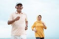 Muslim old couple workout and running at the beach Royalty Free Stock Photo