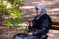 Muslim Woman Relaxing on Bench and Enjoying Ice Cream in Nature Park