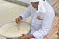 Muslim orthography teacher shows how to write in dhivehi on the sand