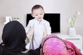 Muslim parents lifting son in living room Royalty Free Stock Photo